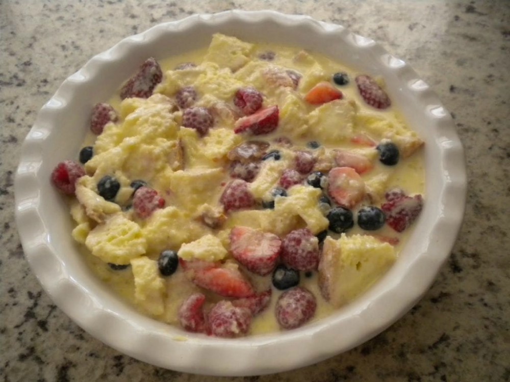 overhead image of mixed berry strata in white casserole