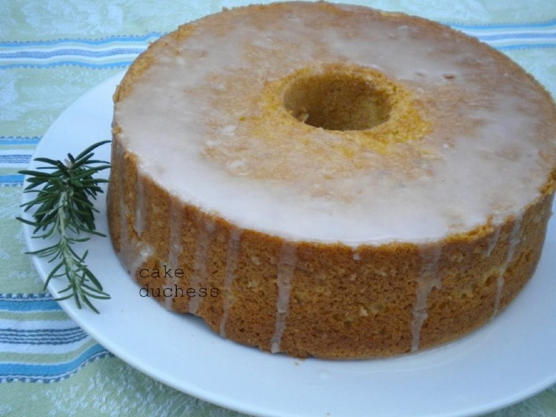 overhead image of lemon rosemary cake on a white plate
