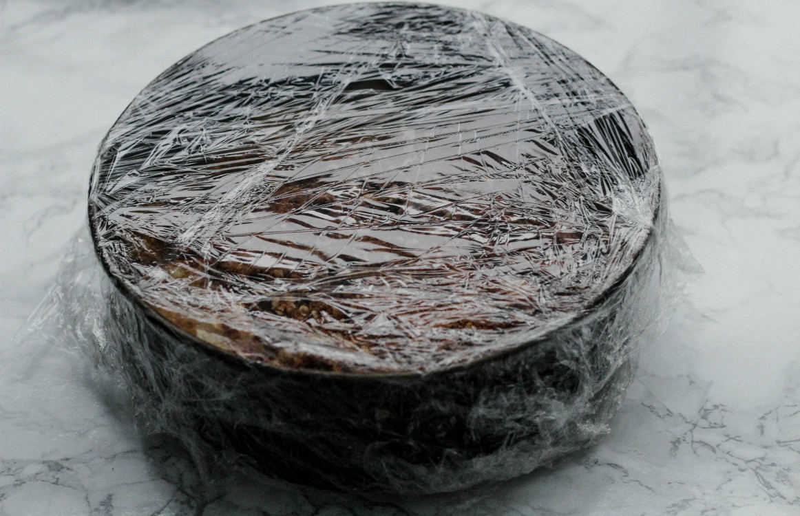 overhead image of cake wrapped with plastic wrap