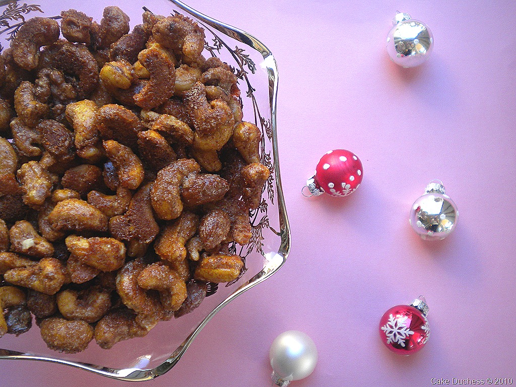 overhead image of nuts in a bowl on pink background