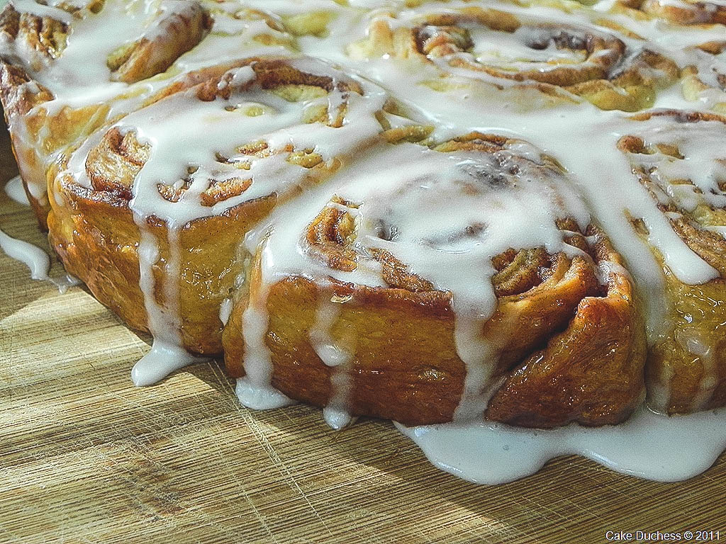 close up image of cinnamon buns with glaze. 