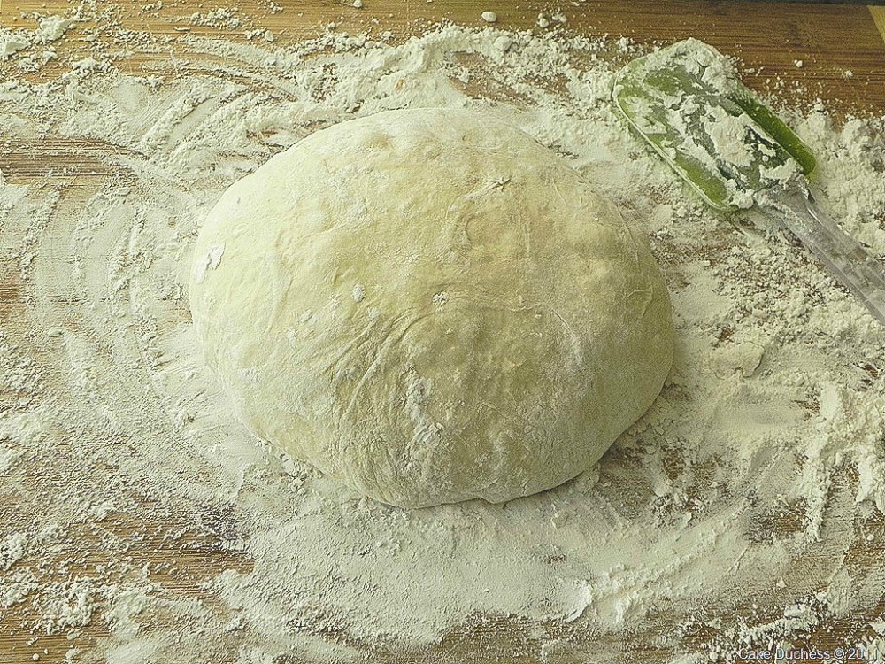 overhead image of prepping dough in flour 