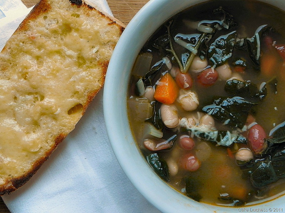 overhead image of zuppa di fagioli italian bean soup with cheese crostini