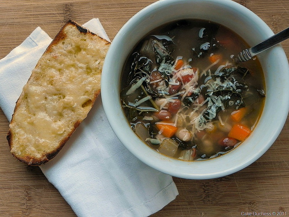 overhead image of bean soup with cheesy bread
