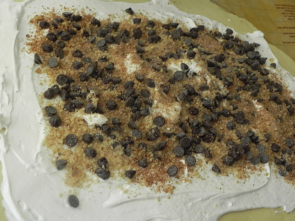 overhead image of meringue and chocolate chips on dough