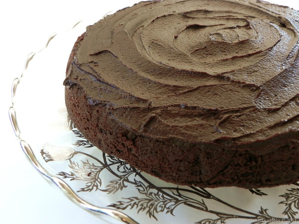overhead image of a chocolate cake on a glass plate