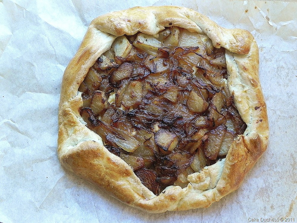 overhead image of savory tart with potatoes, feta, onions, and thyme