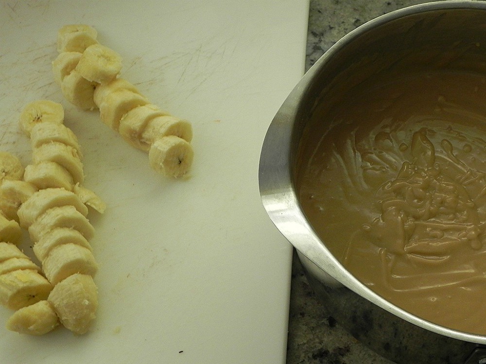 overhead image of sliced bananas and a pan with homemade butterscotch