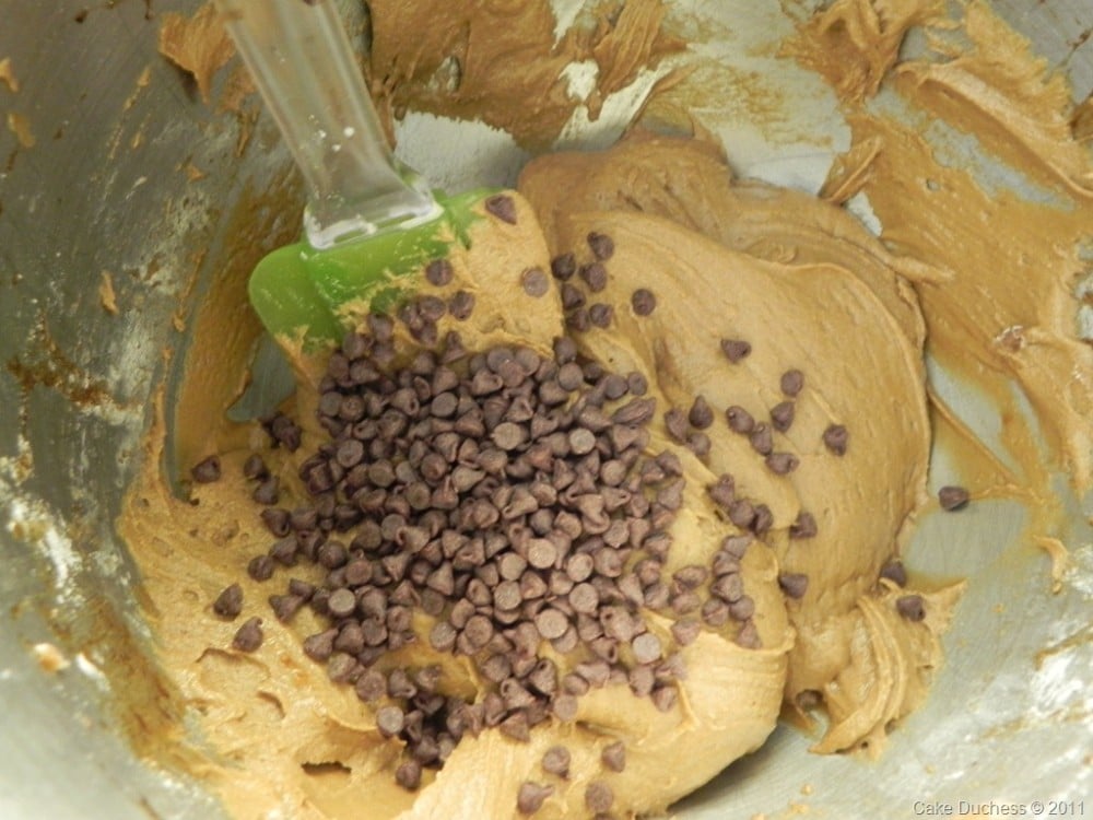 overhead image of chocolate chips folding in cookie batter