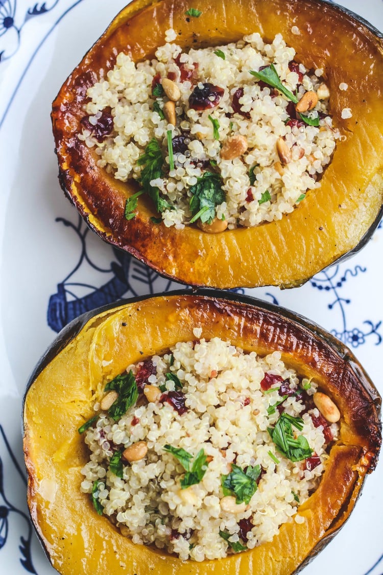 Overhead image of two halves of Stuffed Acorn Squash with Quinoa, Dried Cranberries and Pinoli.