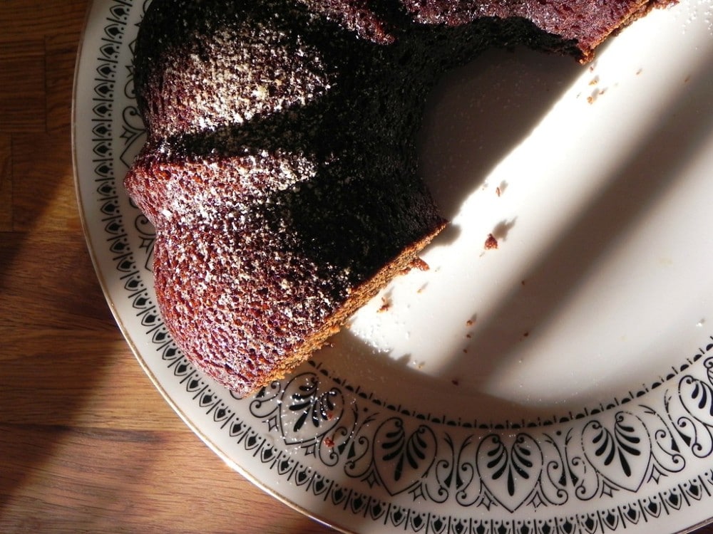 overhead image of a vegan black sticky gingerbread on a serving plate