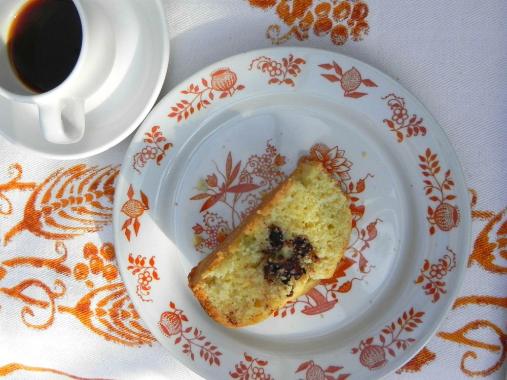 overhead image of cake slice with cup of coffee