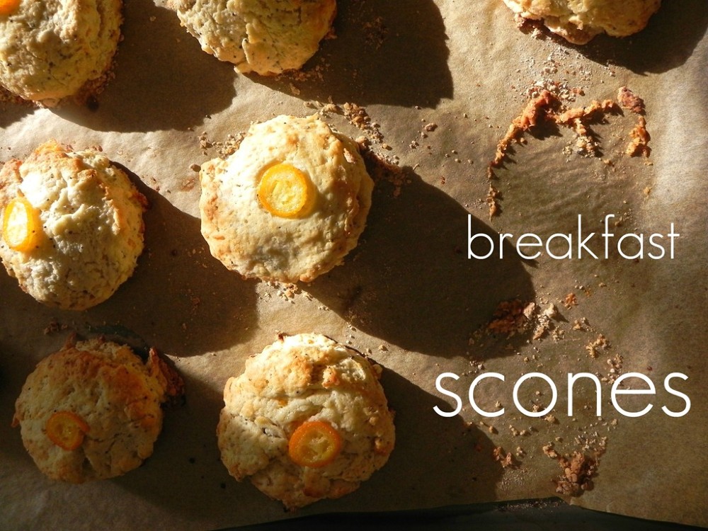 overhead image of kumquat poppy seed scones on a baking sheet