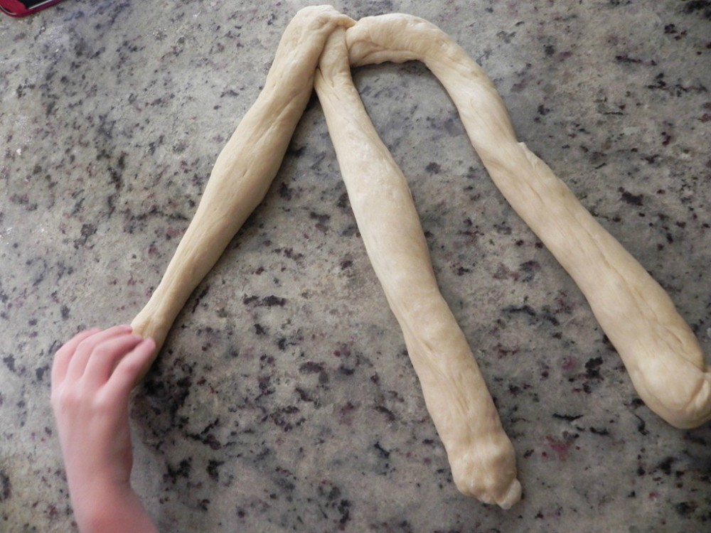 overhead image of three strands of dough on a counter
