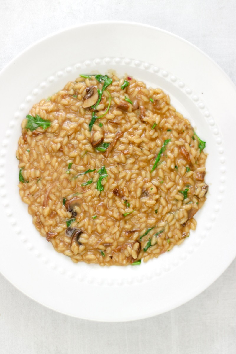 image of risotto with porcini mushrooms on a white plate