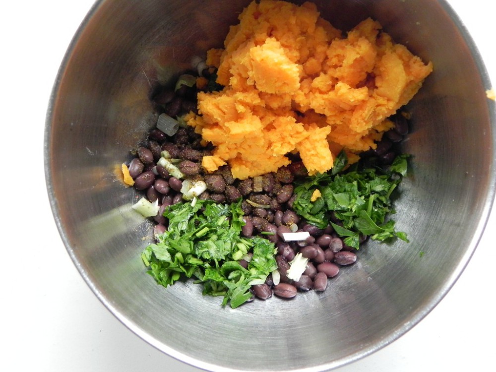 overhead image of sweet potatoes and black beans in a metal bowl