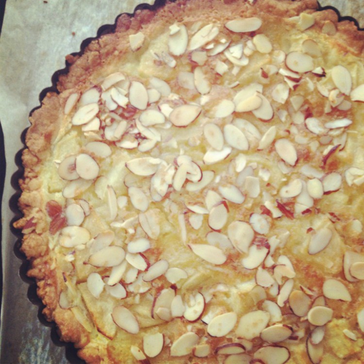 overhead image of apple and almond custard tart on parchment paper