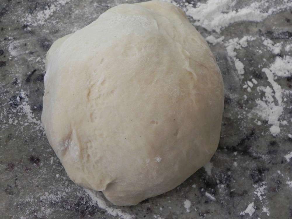 overhead image of dough on marble