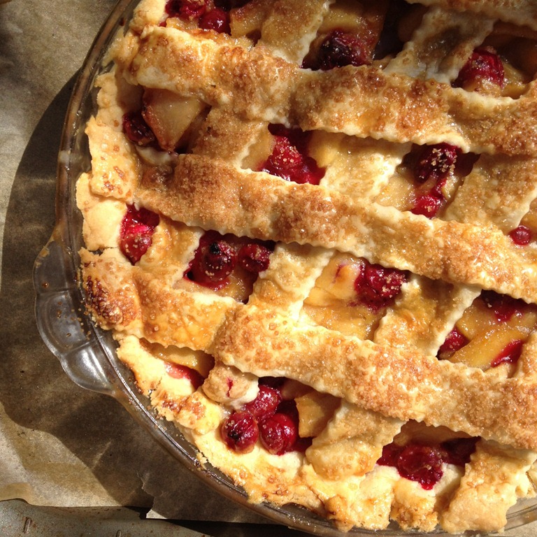 overhead image of cranberry apple pie on parchment paper.