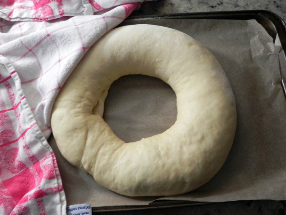 overhead image of ring shaped dough on baking sheet.