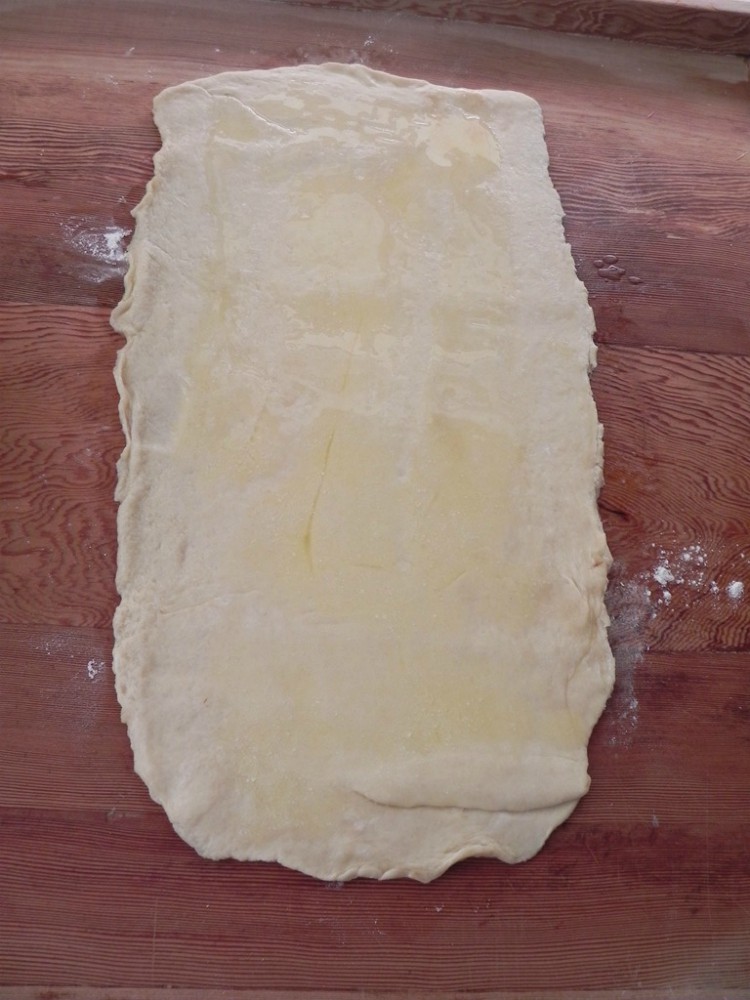 overhead image of rolled on dough on cutting board