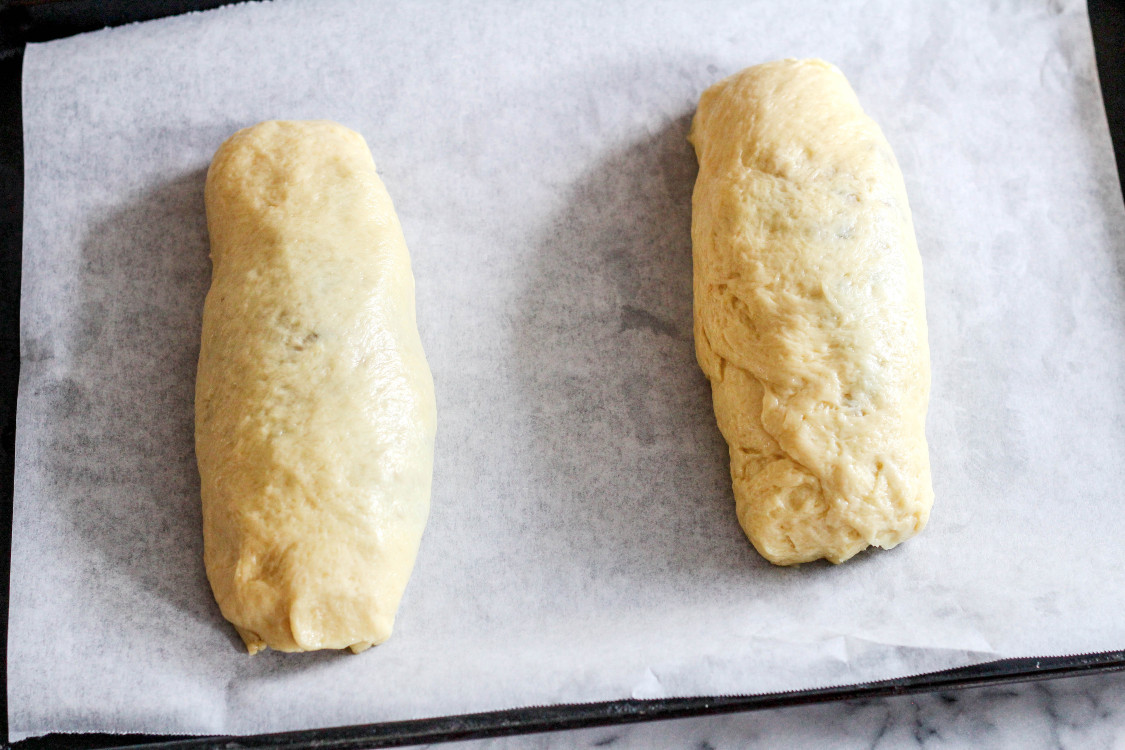 image of rolls of dough on parchment lined baking sheet