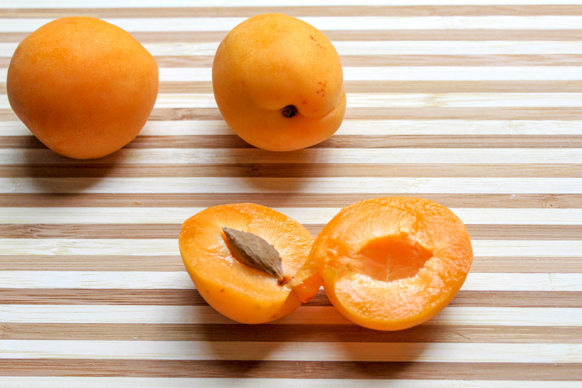 overhead image of apricots on a wooden board