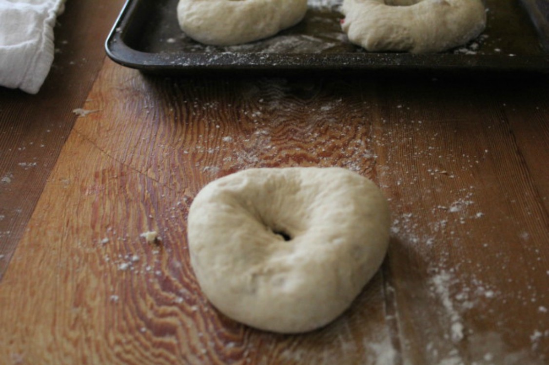 overhead image of bagel dough on wood surface