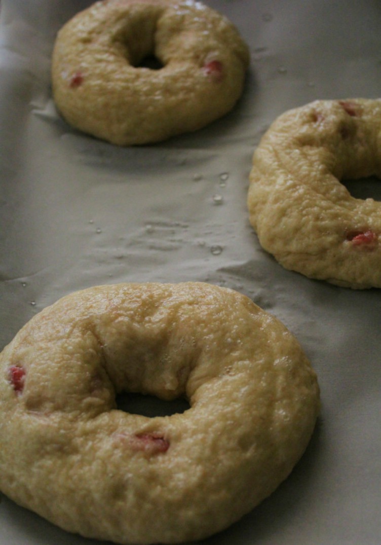 overhead image of bagels on white paper 