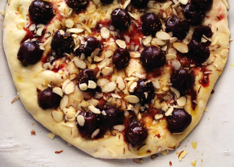 overhead image of cherry almond focaccia on baking paper