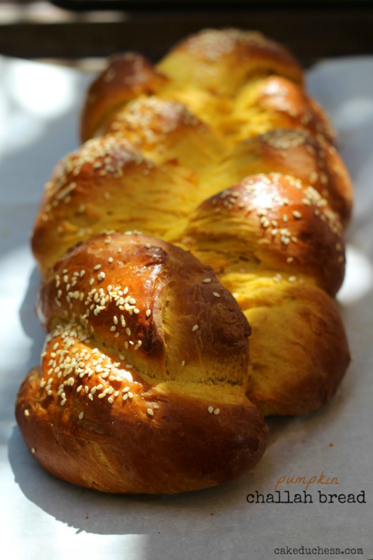 overhead shot of pumpkin challah bread on a baking tray