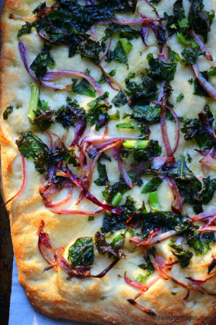 overhead image of kale and red onion pizza