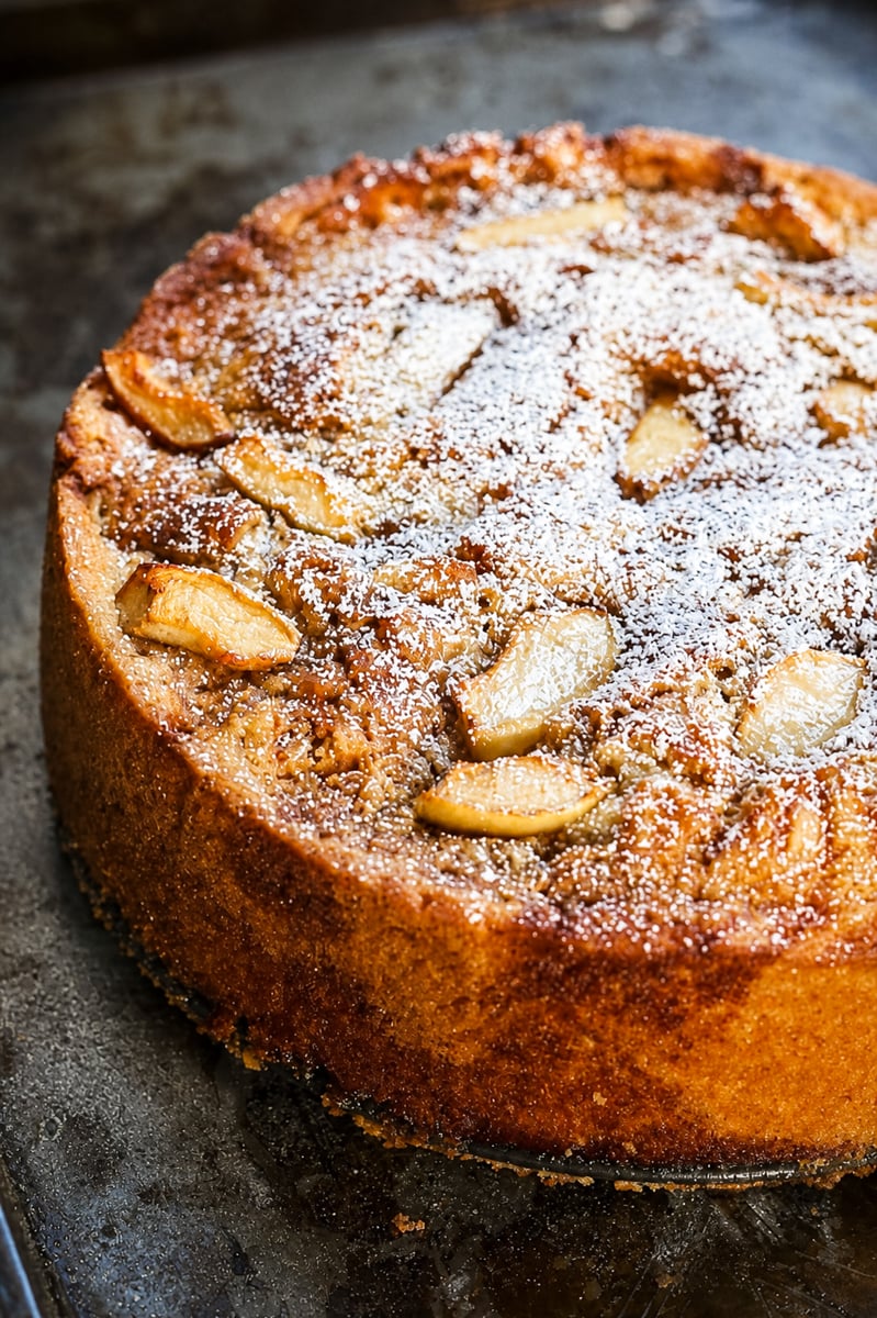 Italian Vegan Apple Cake Italian vegan apple cake dusted with powdered sugar on a white cake stand