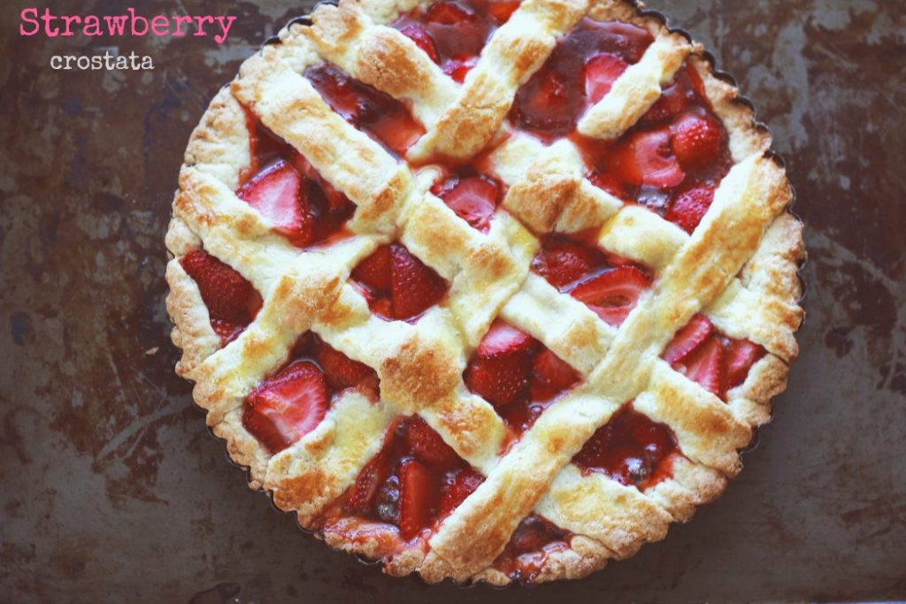 overhead image of a strawberry crostata on a baking sheet