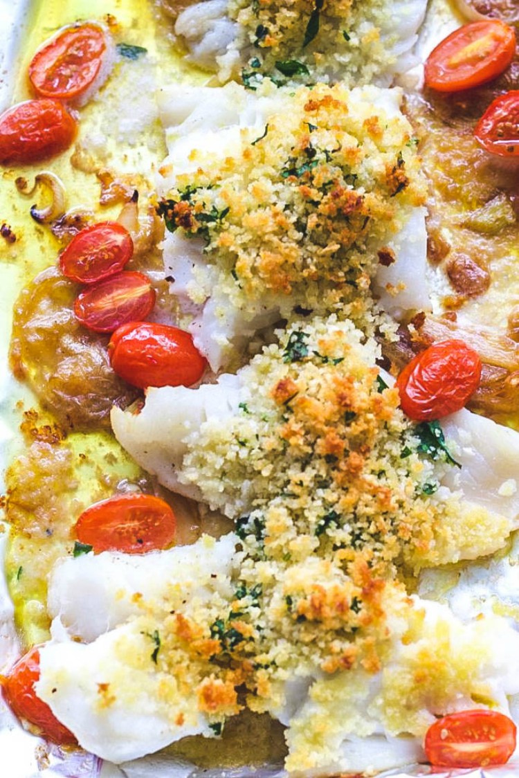 overhead image of baked cod with caramelized onions and cherry tomatoes baccala' al forno