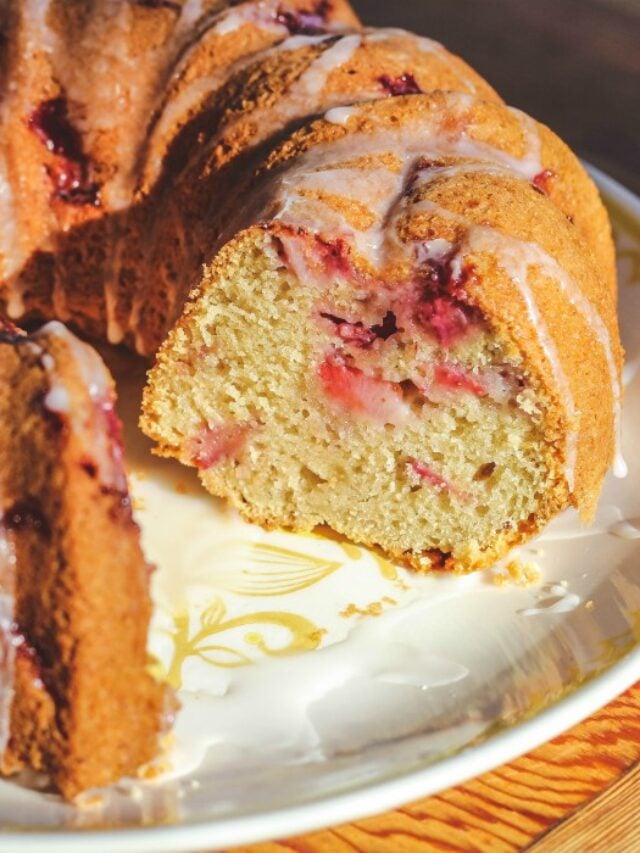 close-up image of sliced homemade strawberry bundt cake on a white plate.