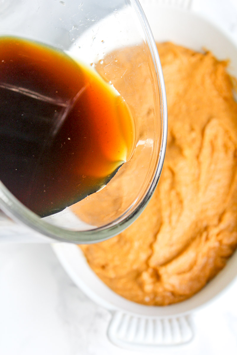 image of pouring brown sugar syrup on pumpkin pudding cake.