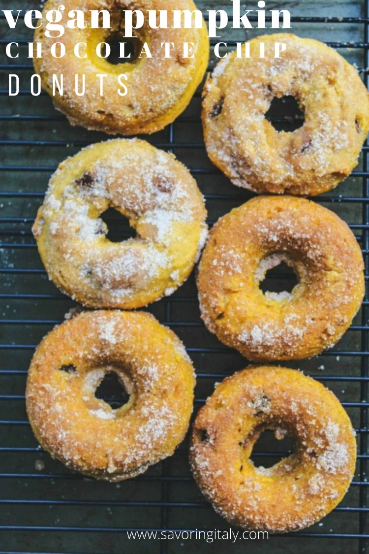 overhead image of vegan pumpkin chocolate chip donuts on baking rack