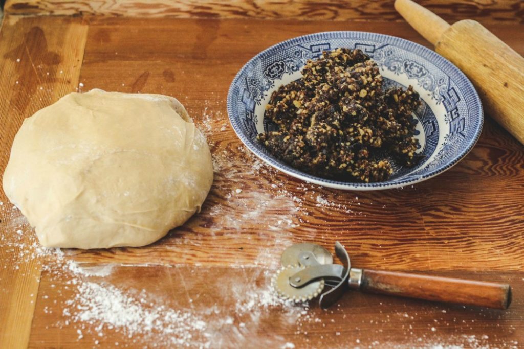 overhead image of dough and fig filling on pastry board