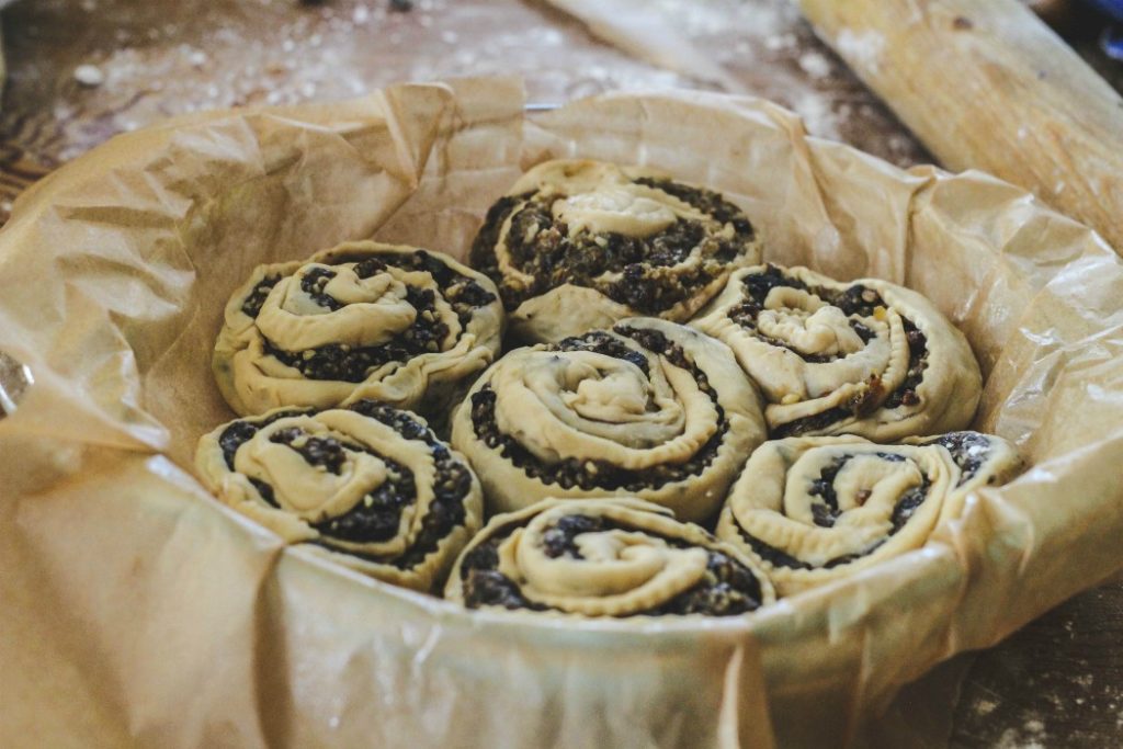 overhead image of fruit filled pastries in parchment lined pan