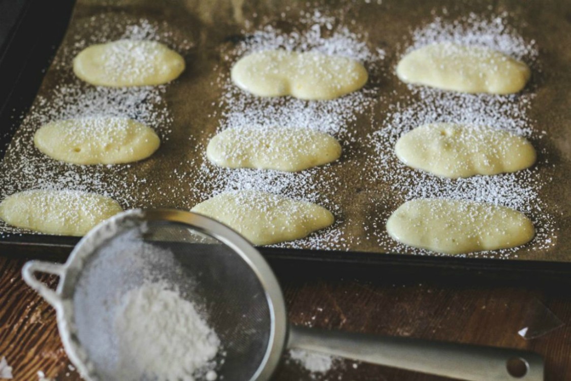 overhead image of Italian ladyfinger cookies on baking tray 