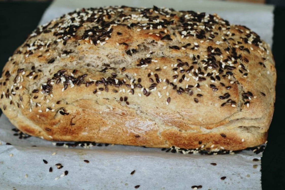 overhead image of seeded loaf of bread