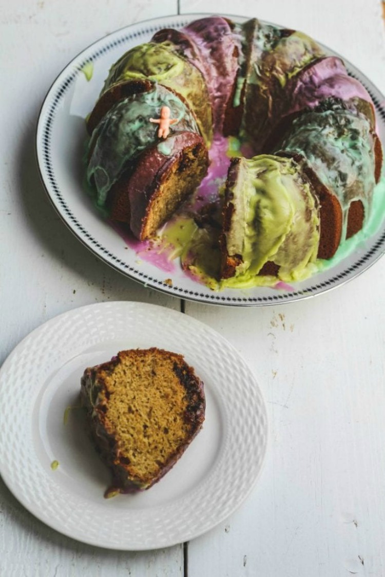 overhead image of a colorful bundt cake sliced on a white plate