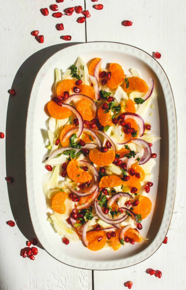 overhead image of orange salad on white plate