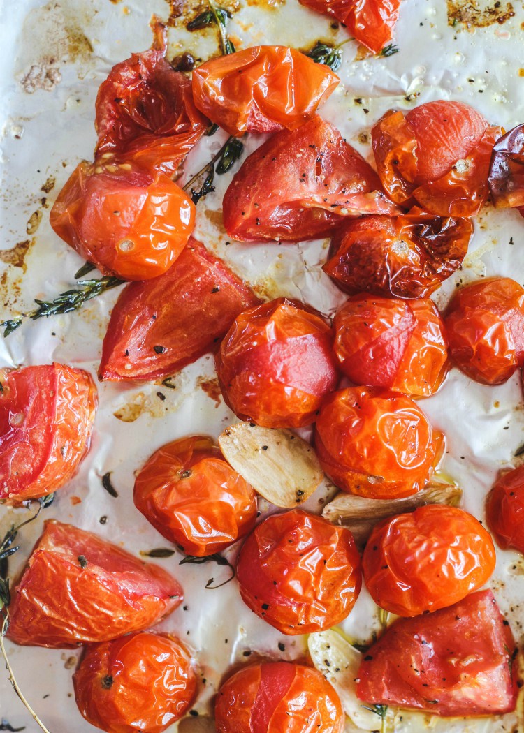 overhead image of roasted cherry tomatoes on baking tray