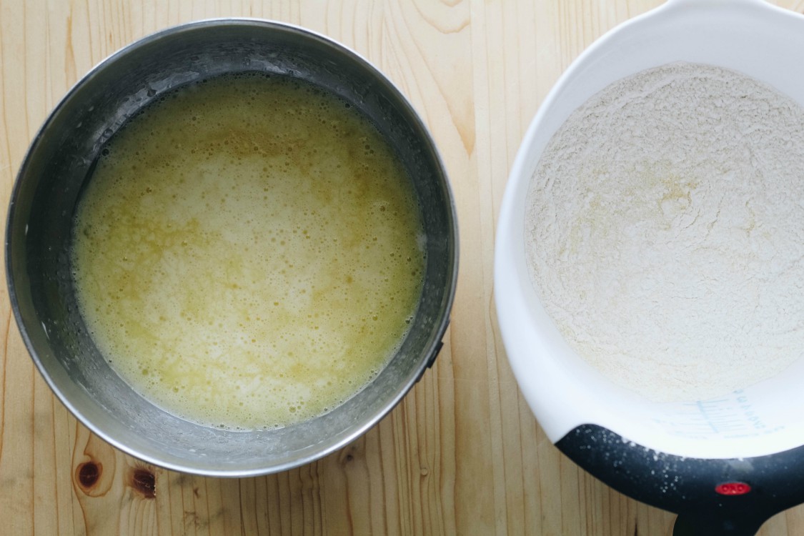 overhead image of making vegan peach polenta cake.