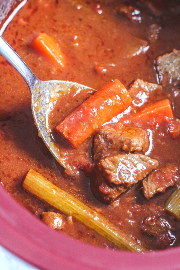 overhead image of Italian beef stew in red pot