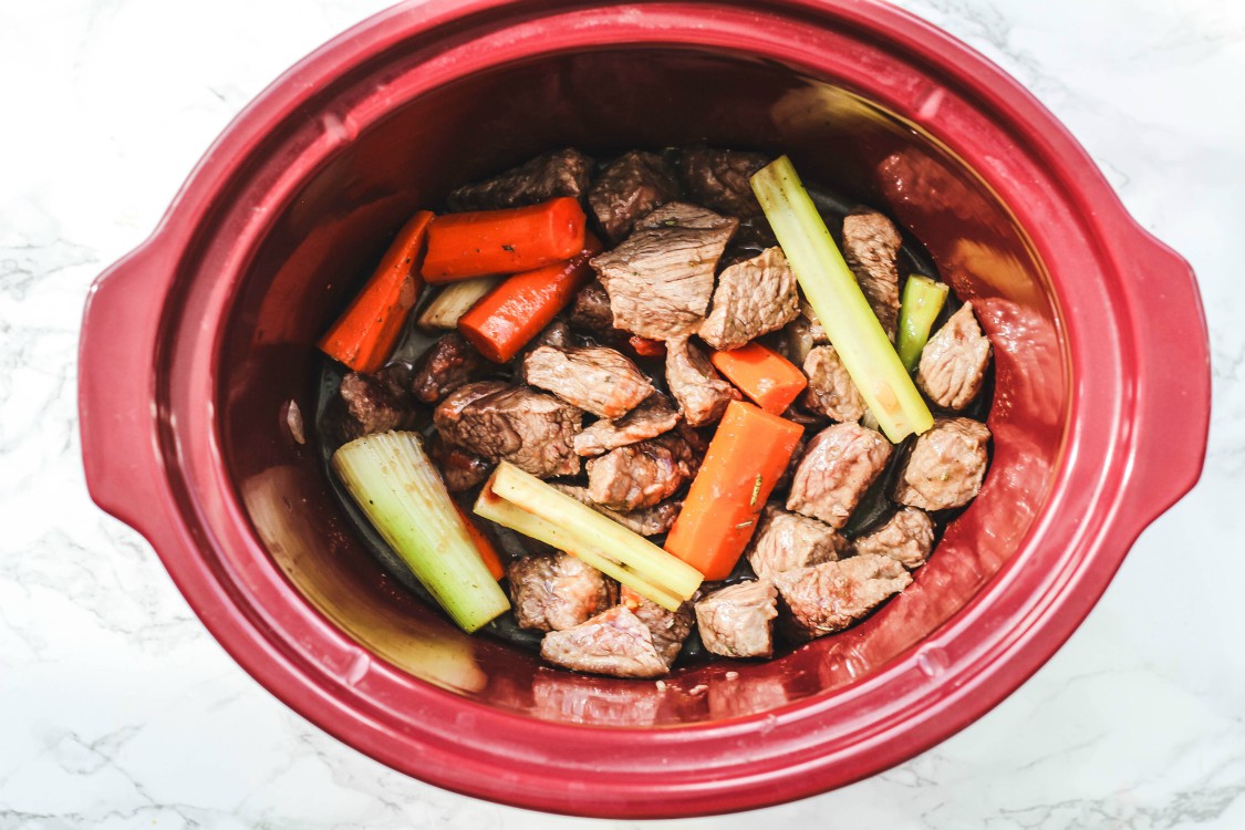 overhead image of making beef stew in slow cooker