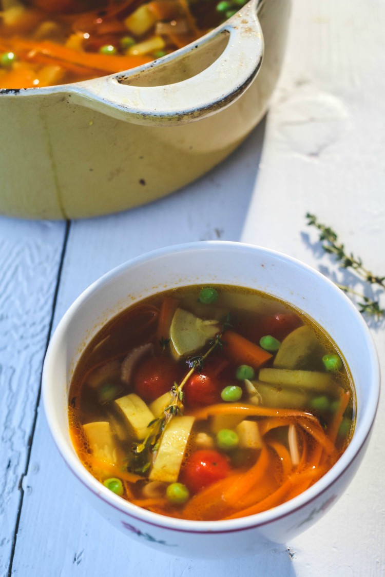 overhead image of summer minestrone in white bowl