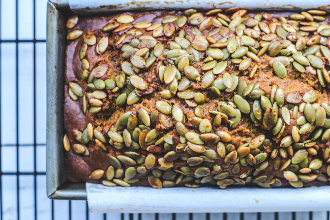 loaf of bread with pumpkin seeds on top